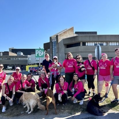 The Breast Imaging Kingston team at this year's CIBC Run for the Cure. A group of KHSC employees and families wearing pink shirts in a field.