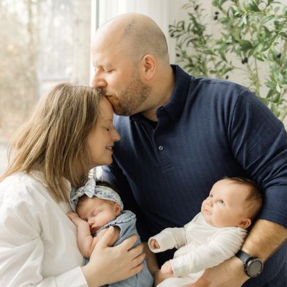 a couple holding two babies
