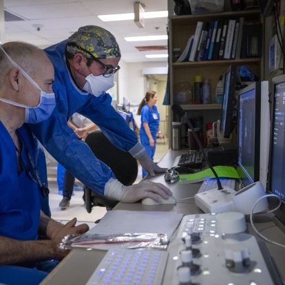 A physician and a medical radiation technologist in the IVR control room