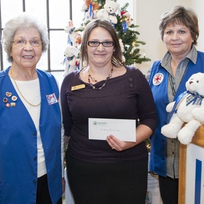 Lynn Brown from Kawartha Credit Union in Kingston presents a cheque to KGH Auxiliary campaign organizers during the kick off event.