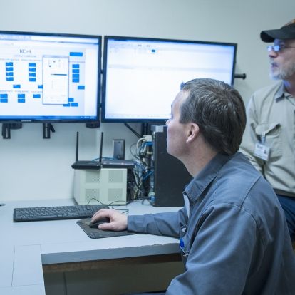 (From left) Peter Moeslinger, Master Electrician and Brad Wood, Refrigeration and Air Conditioning Mechanic keep an eye on the program that controls our air handling systems.