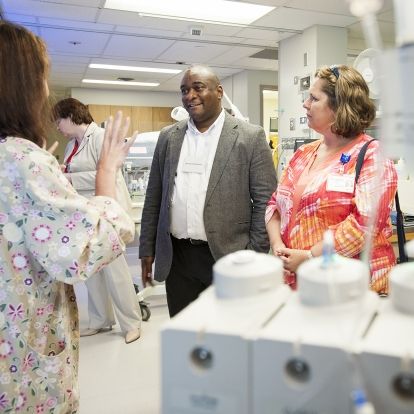 Bernard Roberson from Georgia Regents Health and Angela Morin, KGH Patient Experience Advisor, talk with staff in our newly renovated Neonatal Intensive Care Unit about the new Family Integrated Care model they are helping pioneer.