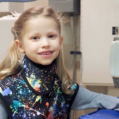 Ella models the new pediatric apron that was inspired by her experience in the Diagnostic Imaging department