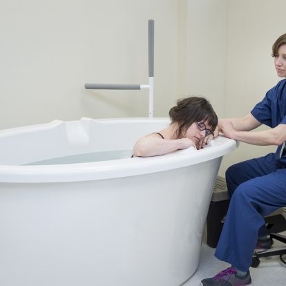 A patient demonstrates how the tubs will be used under the supervision of a registered midwife.