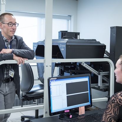 Dr. Gord Boyd and PhD candidate Jessica Vanderlinden with the KINARM in the W.J. Henderson Centre for Patient Oriented Research.