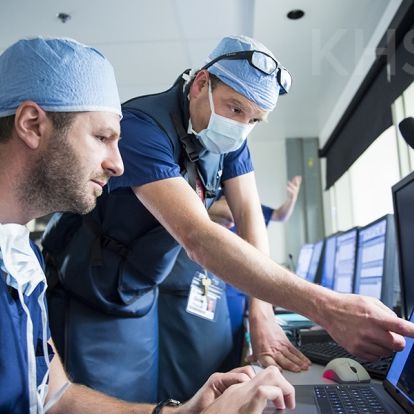 Cardiologist, Dr. Ben Glover (R) speaks with cardiac surgeon, Dr. Gianluigi Bisleri (L) prior to their procedure at KHSC.