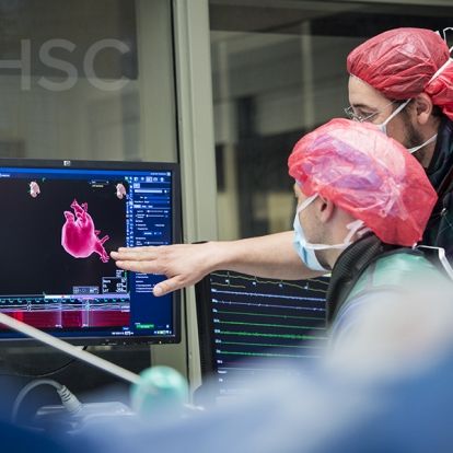 Support members from the team monitor various aspects of the procedure throughout the process.