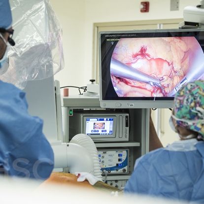 Cardiac surgeon, Dr. Gianluigi Bisleri (L) can see where he is working on the monitors inside the operating suite at KHSC.