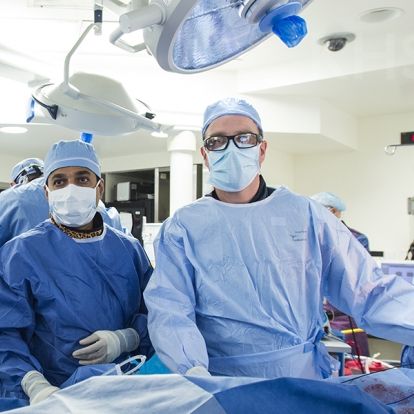 Cardiologist, Dr. Ben Glover (R) works at the patients' side during this hybrid ablation procedure at KHSC.