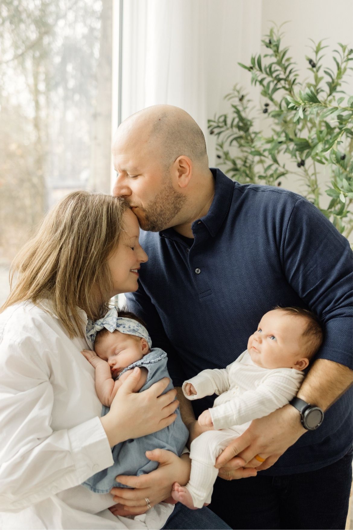 a couple holding two babies