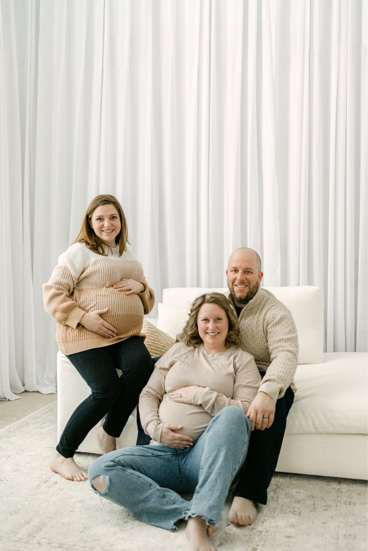 a married couple sit beside their surrogate mother
