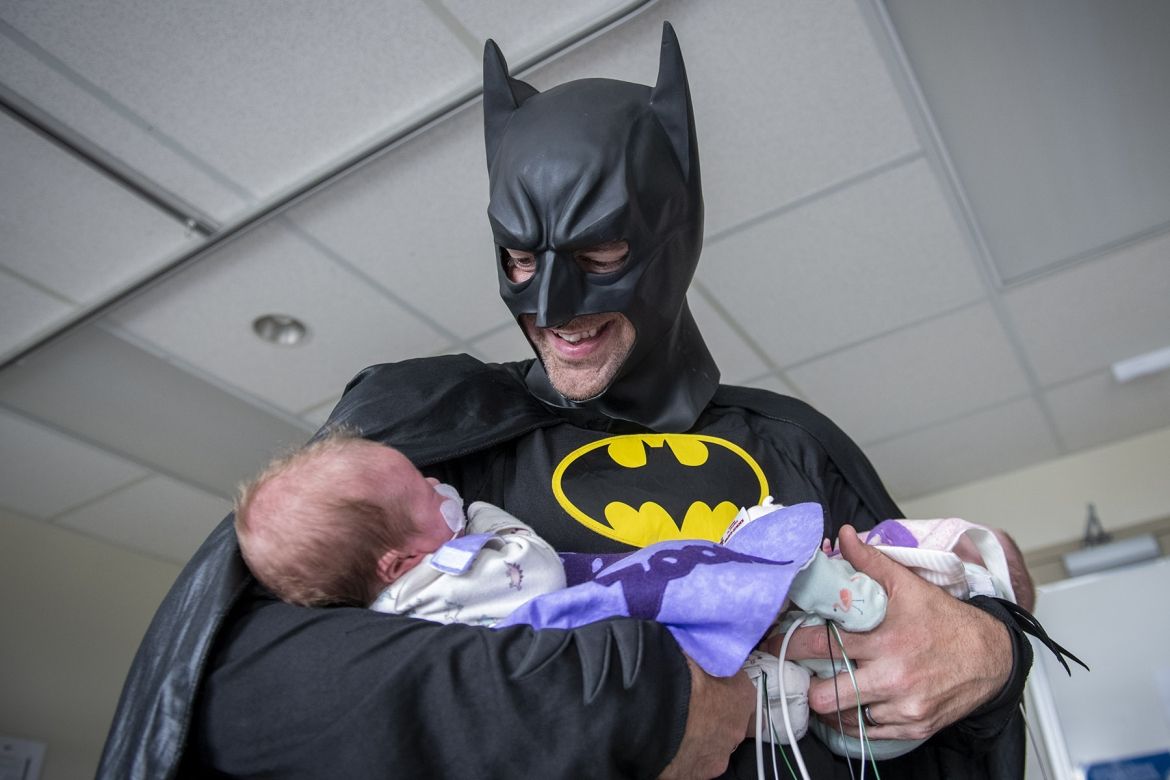 batman holding a baby
