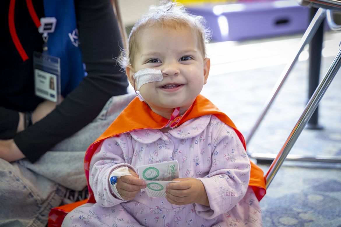 a young patient wearing a cape at KHSC