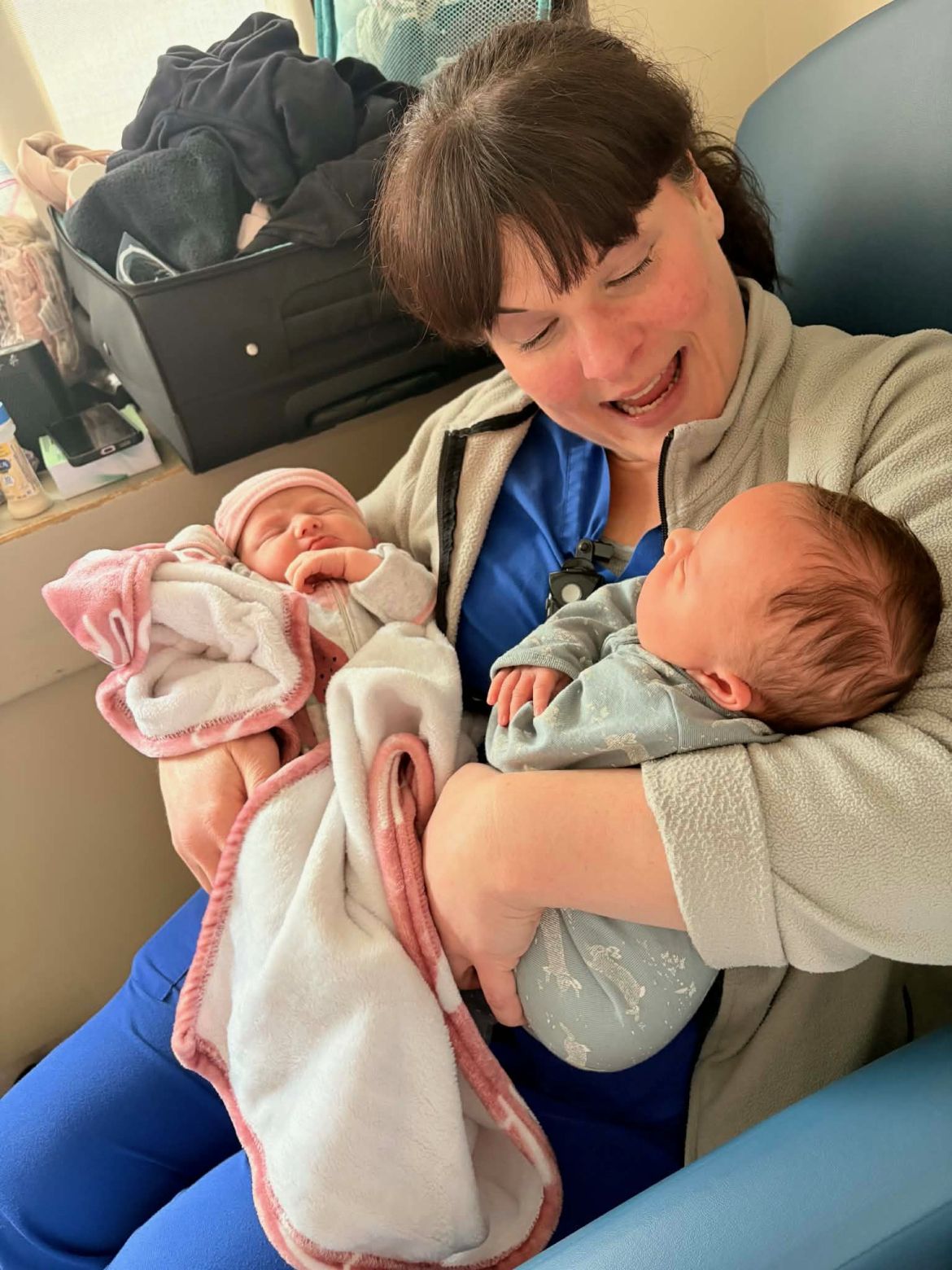 a labour and delivery nurse holds two young babies