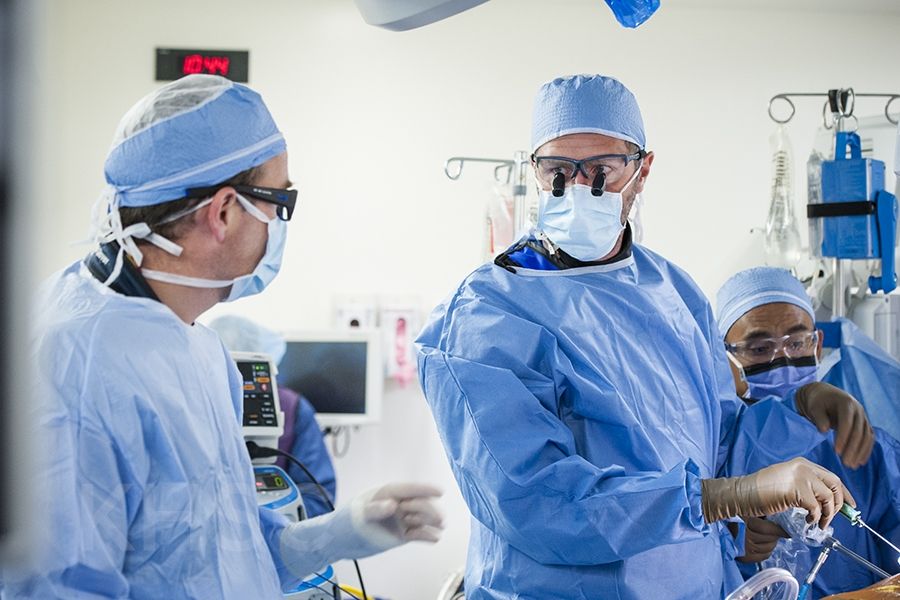 Cardiac surgeon, Dr. Gianluigi Bisleri (R) works along side cardiologist, Dr. Ben Glover (L) during the procedure at KHSC.