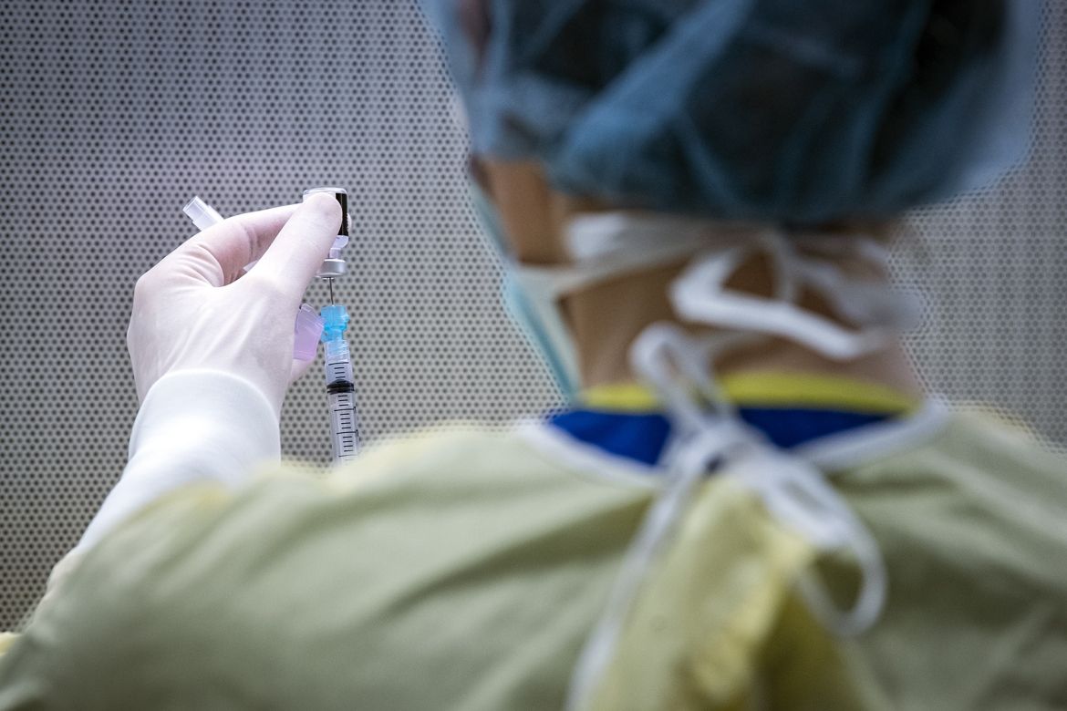 COVID-19 vaccination is drawn into a syringe