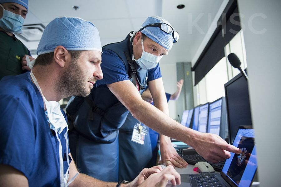 Cardiologist, Dr. Ben Glover (R) speaks with cardiac surgeon, Dr. Gianluigi Bisleri (L) prior to their procedure at KHSC.