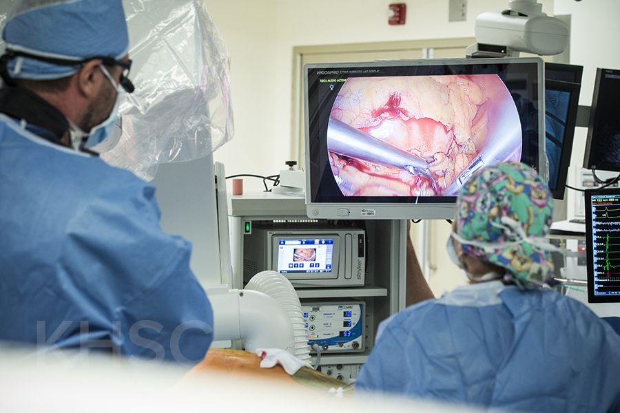 Cardiac surgeon, Dr. Gianluigi Bisleri (L) can see where he is working on the monitors inside the operating suite at KHSC.