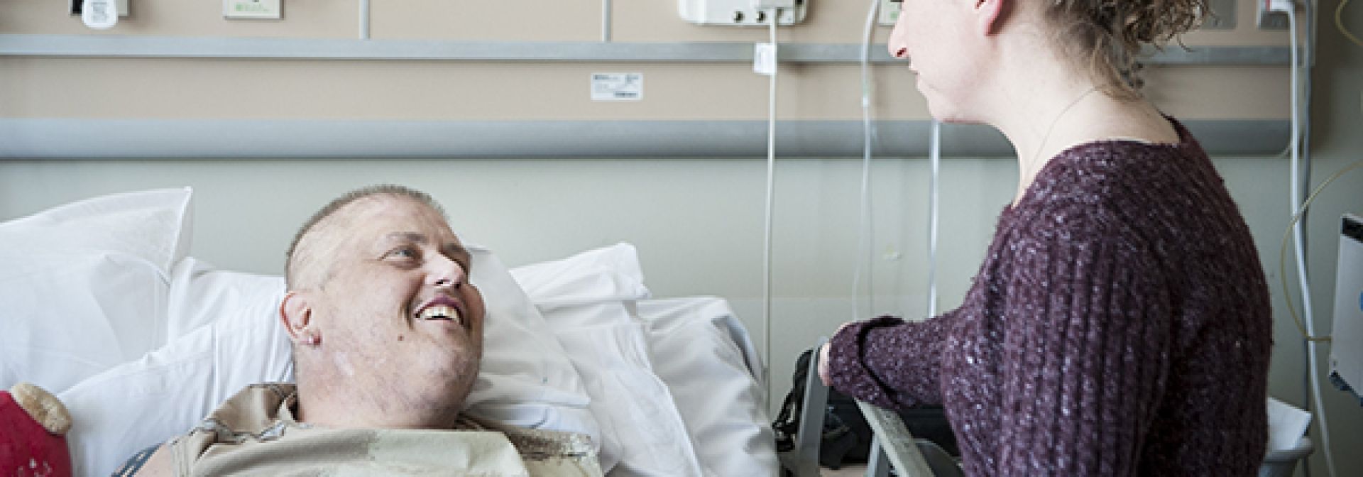 A family member visiting with a pateint on an in-patient unit.