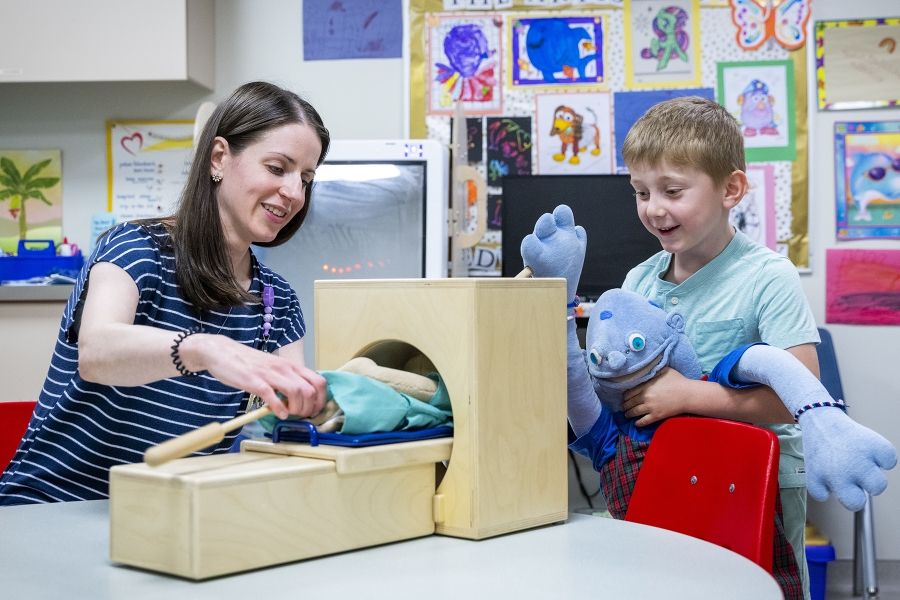 a child life expert playing with a young patient