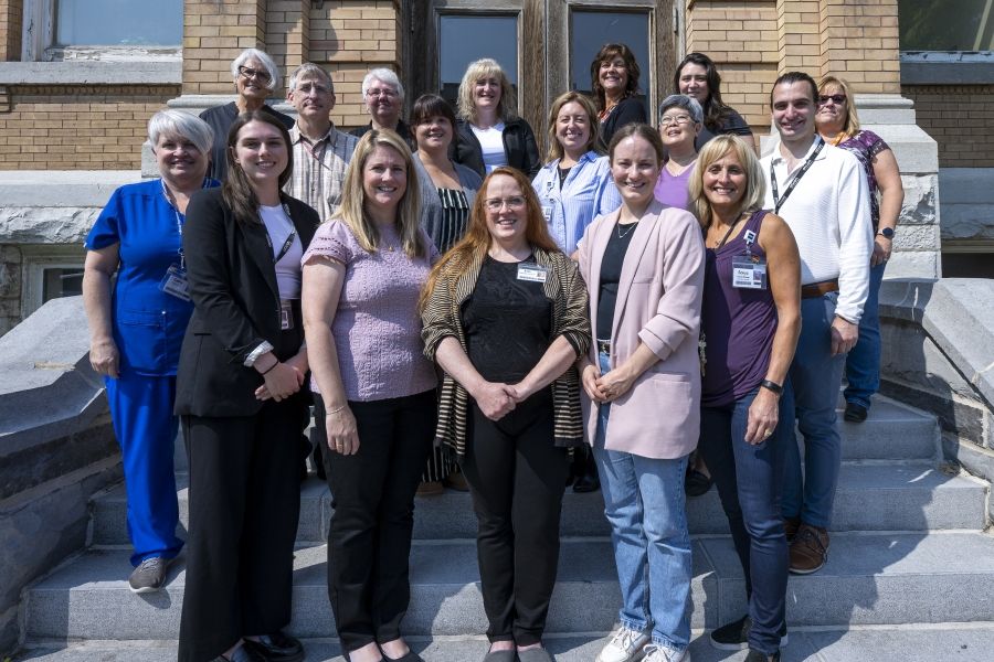 a group of people stand in front of Hotel Dieu Hospital