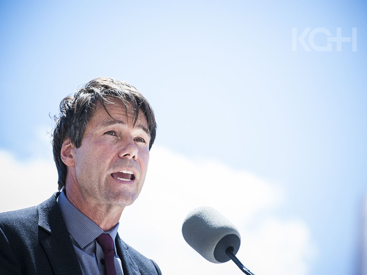 Dr. Eric Hoskins speaking at an event in Kingston