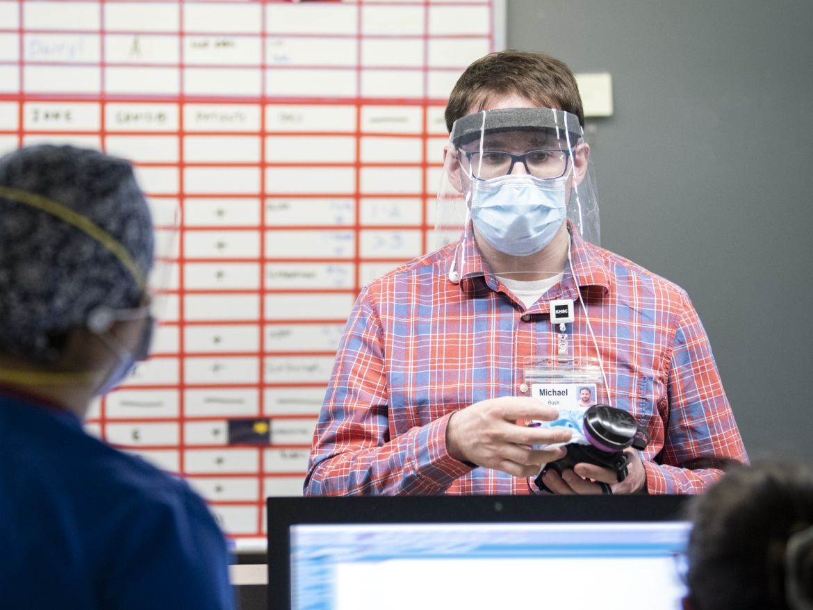 Occupational Health, Safety & Wellness team working on the COVID unit with staff.