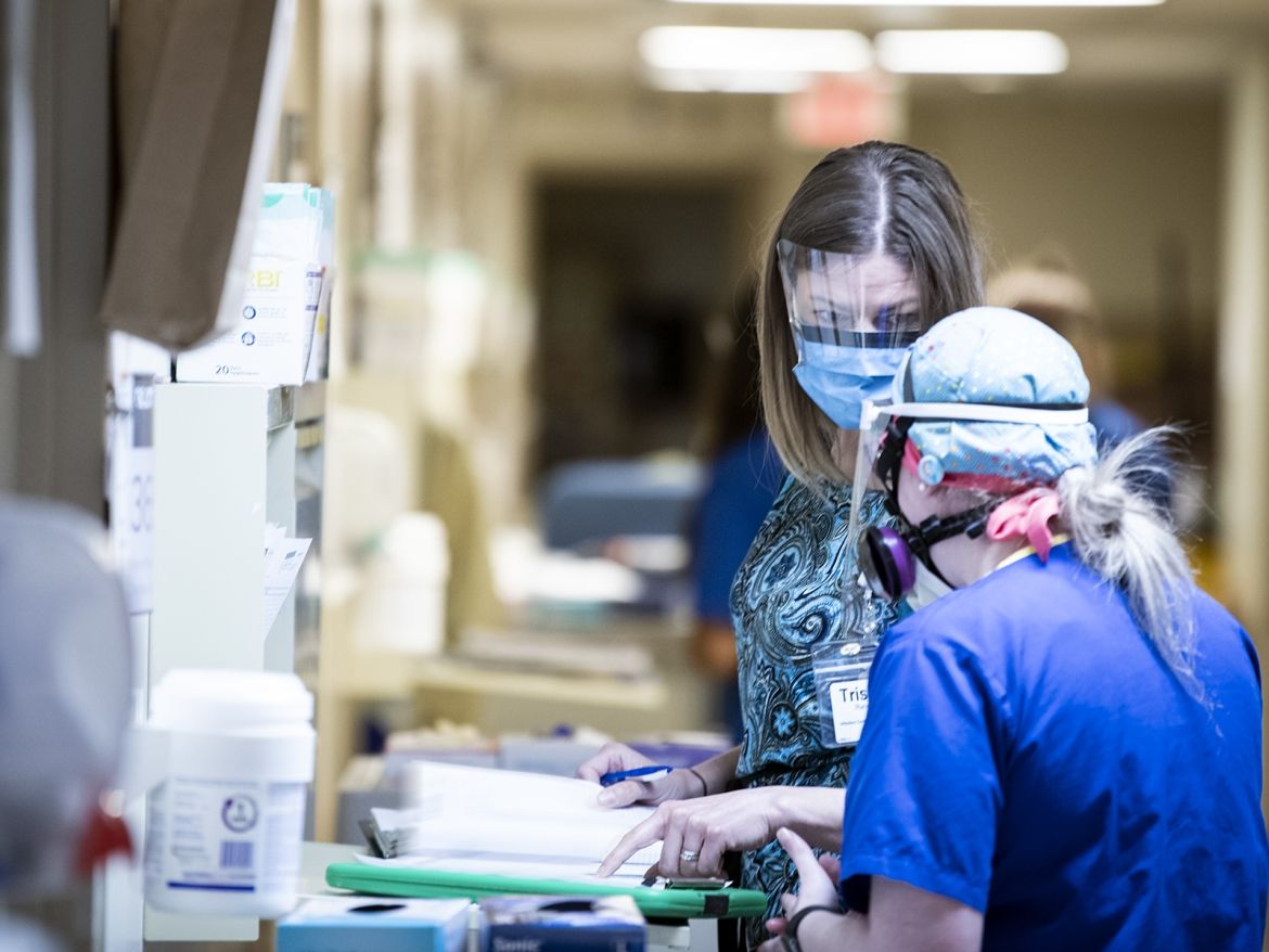 IPAC staff work with nursing teammates on the COVID unit.