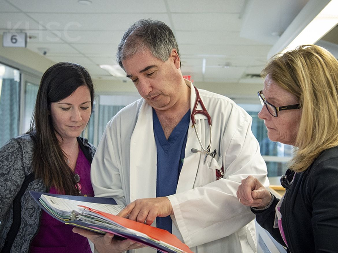 Dr. Adrian Baranchuk talks with clinical staff on the unit at KHSC