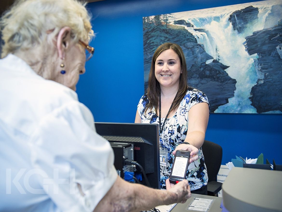 Staff in the cancer centre hand out pagers to patients in the waiting room.
