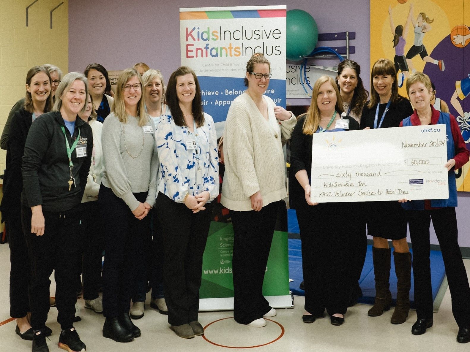 KHSC Volunteer Services to the Hotel Dieu Hospital (HDH) site present a cheque to the KidsInclusive team.