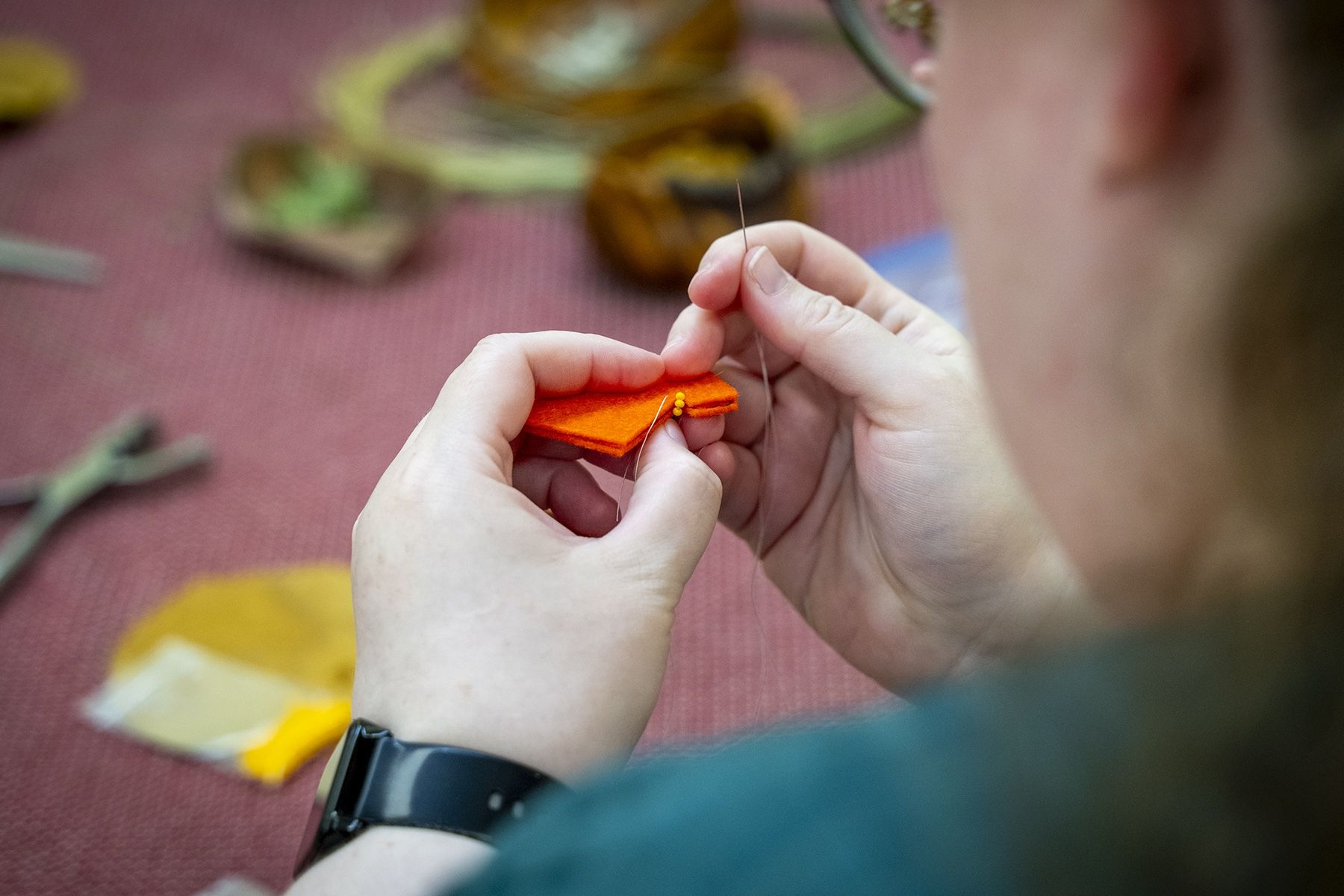 staff member participating in craft circle