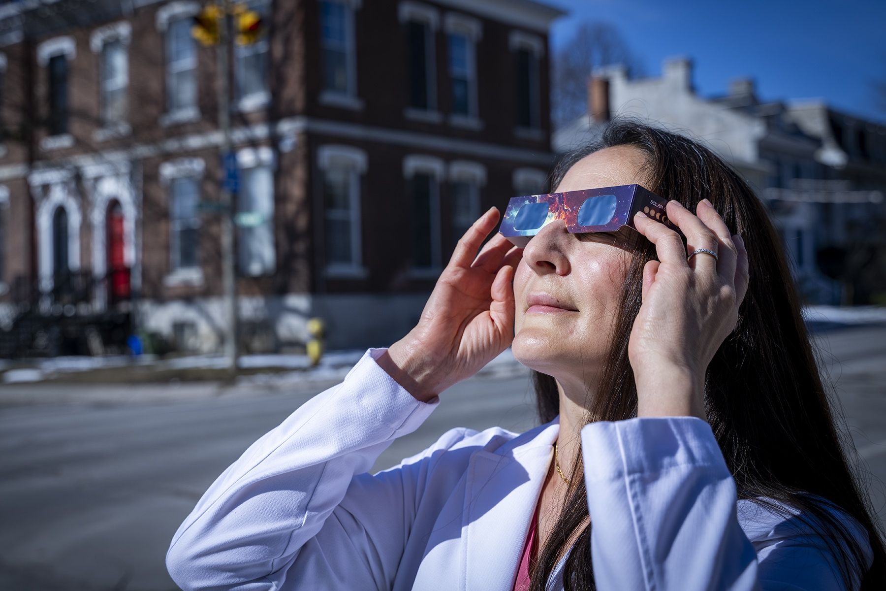 Dr. Strube demonstrates how to wear protective eclipse glasses.