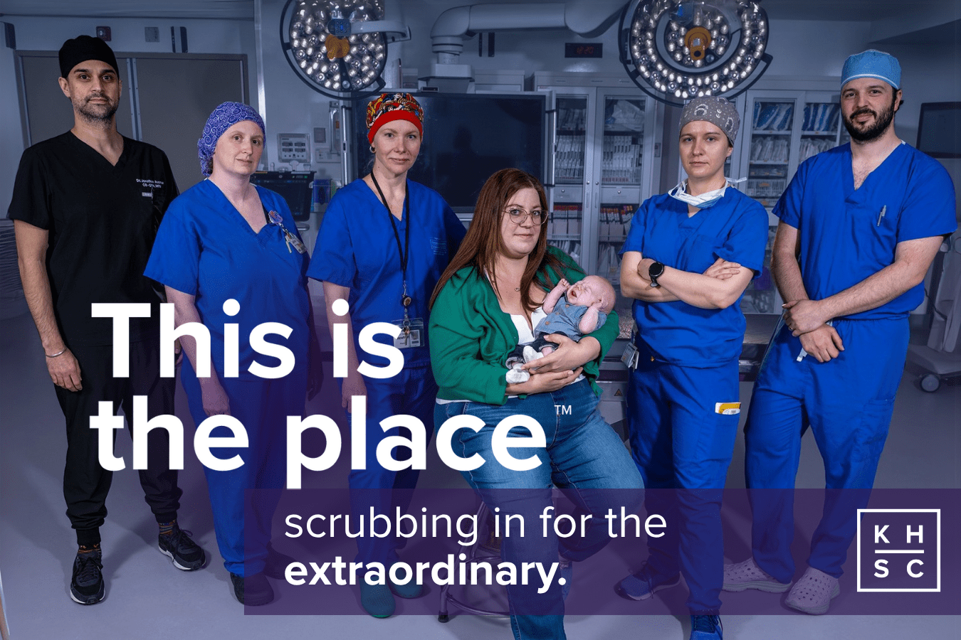 a group of medical experts stand behind a woman holding a newborn baby