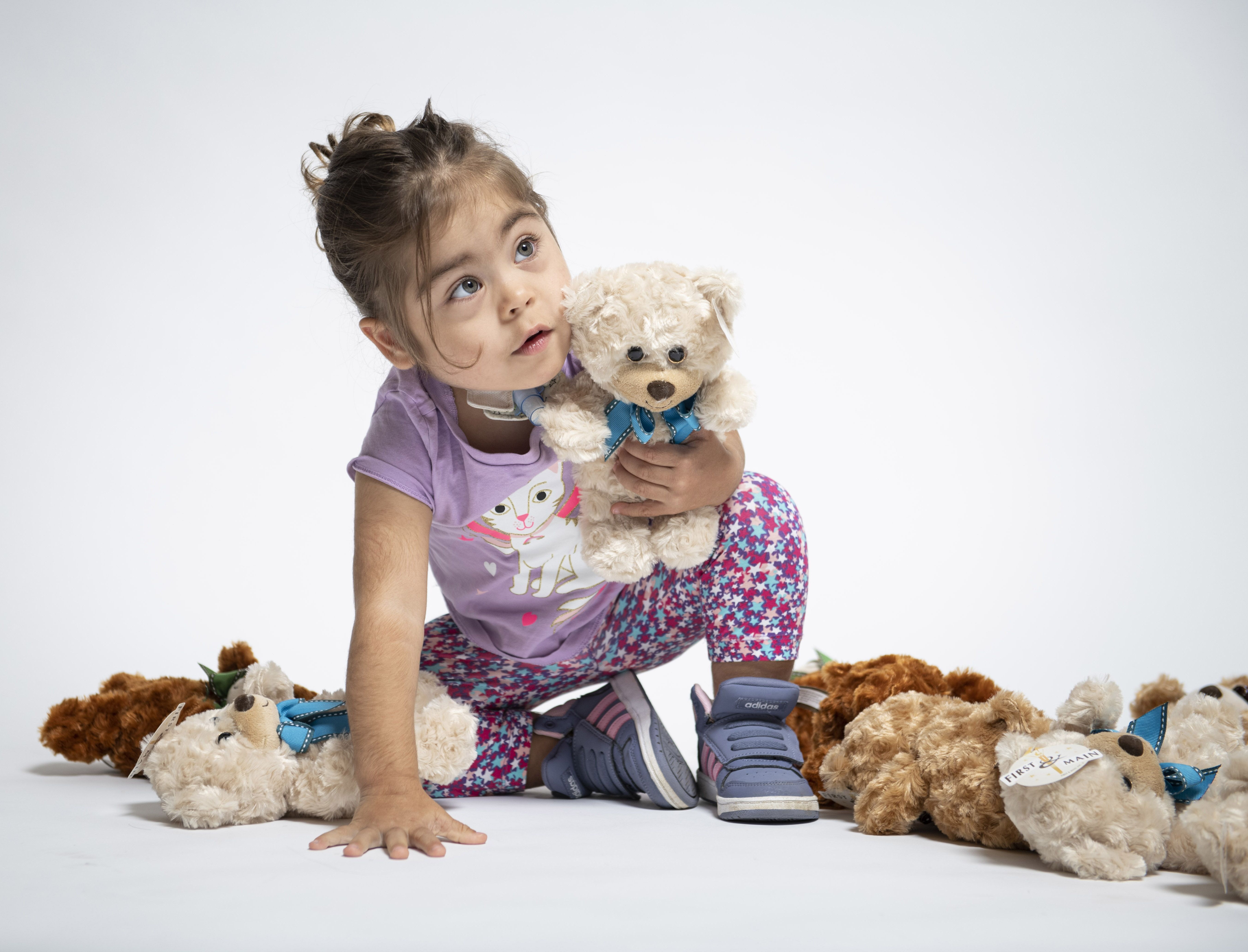 image of child with teddy bears