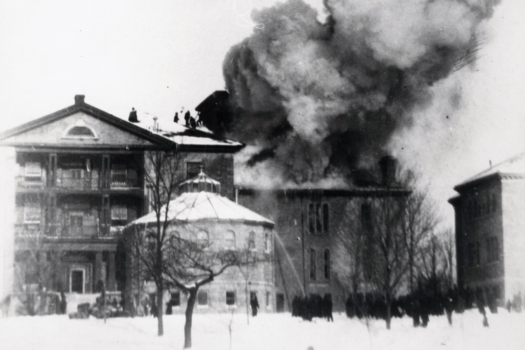 Fire engulfs the Watkins Wing in 1897. Firemen and volunteers managed to save the main building by passing buckets of water.