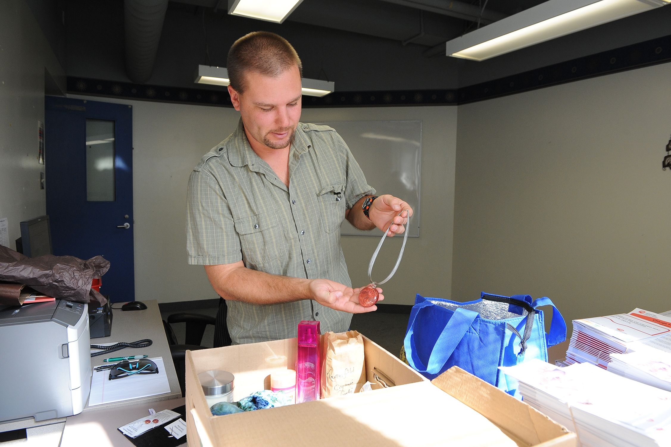 Chris Hammer, KGH Employee Campaign Coordinator, organizing donated items for the Early Bird gift basket draw.