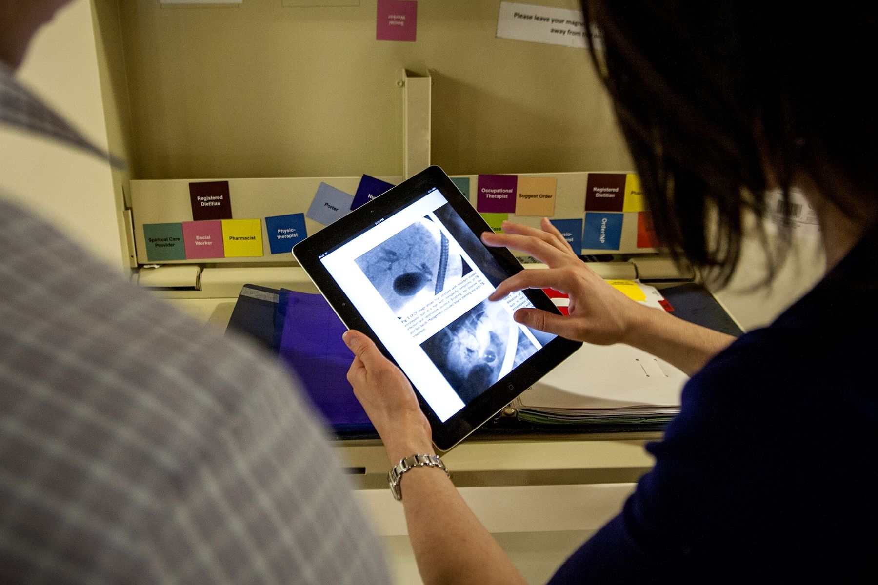 Dr. Catherine Barry uses her new iPad to review imaging files for patients on one of the units at KGH.