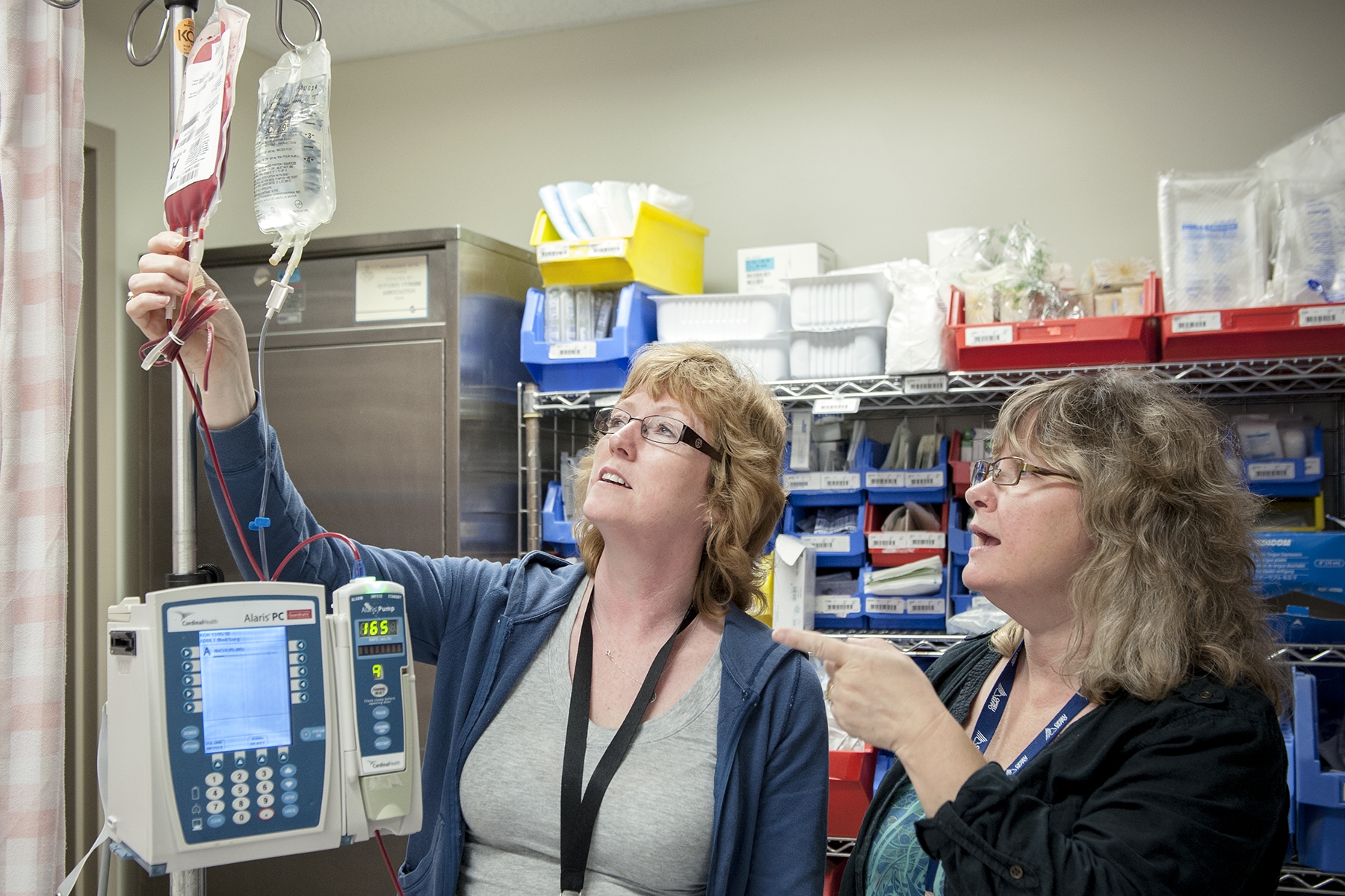 Transfusion Safety Officer Beverly Weaver (right) and Registered Nurse Suzanne Bashall discuss a blood transfusion being performed in our Post Anaesthetic Care Unit.