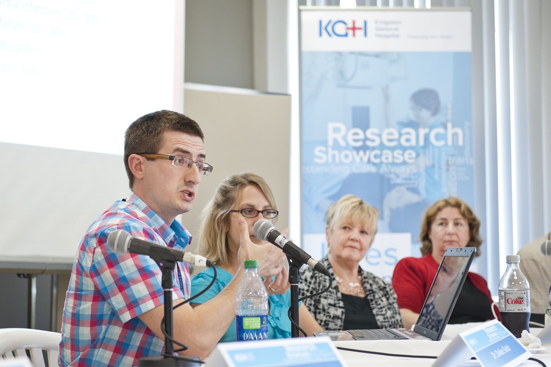 Researchs present their findings to a crowd at KGH.