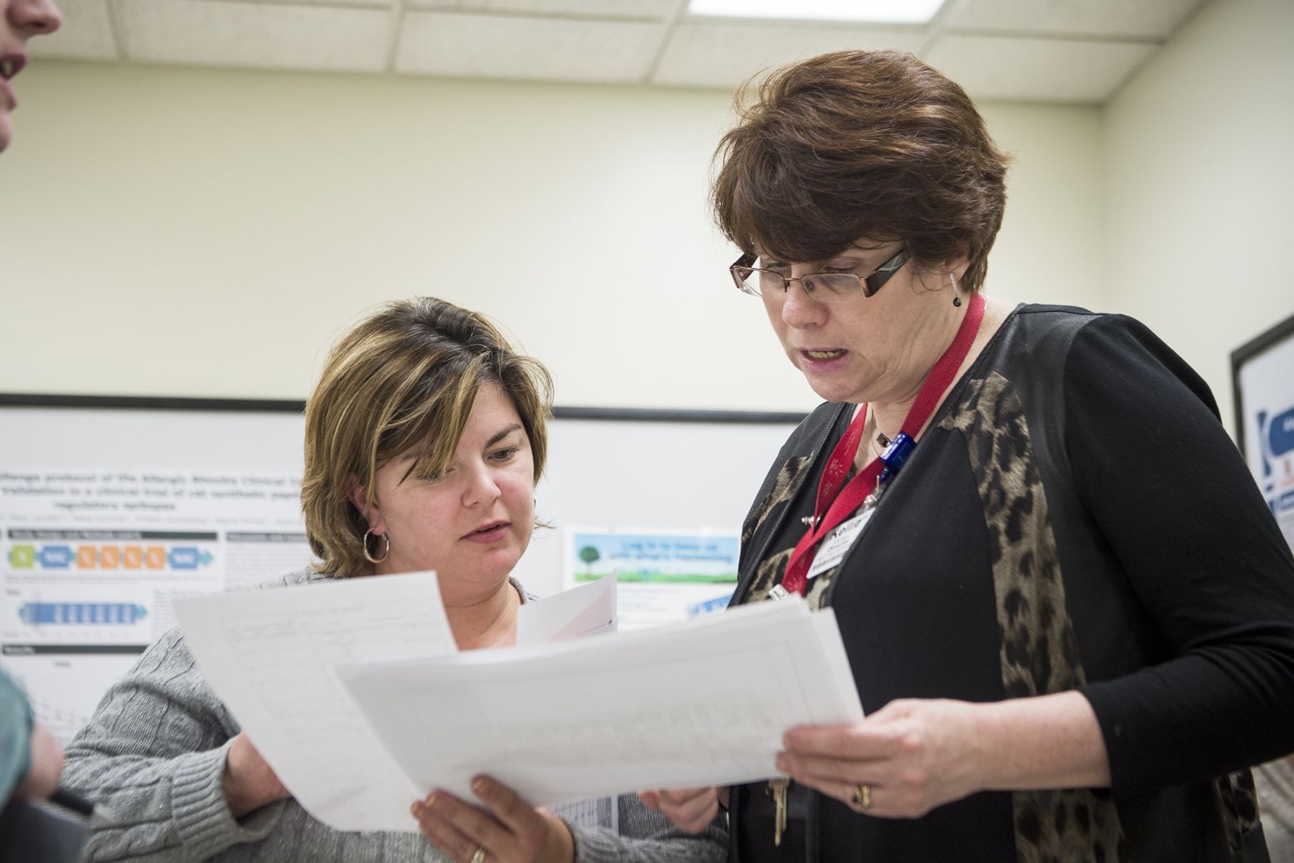 (From left) Rachael Smith-Tryon, Manager of Admitting, Registration and Switchboard and Kellie Kitchen, Program Operational Director for OBS/GYN/PEDS/SPA, have a quick meeting as part of the daily huddles