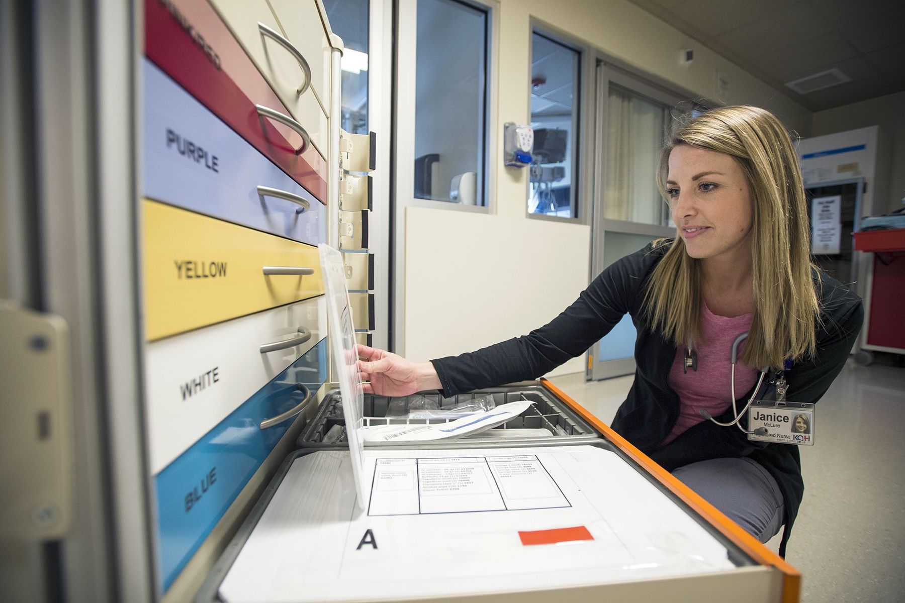 Registered Nurse Janice McLure checks out the new pediatric rainbow cart that recently arrived on Kidd 10.