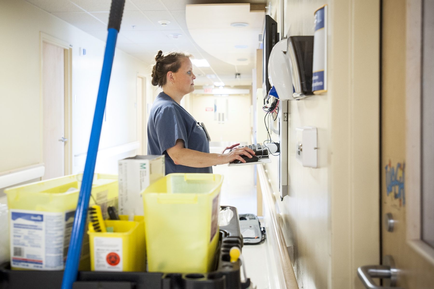 Debora Petrie, Environmental Services Assistant, goes online to let people know another bed is clean.