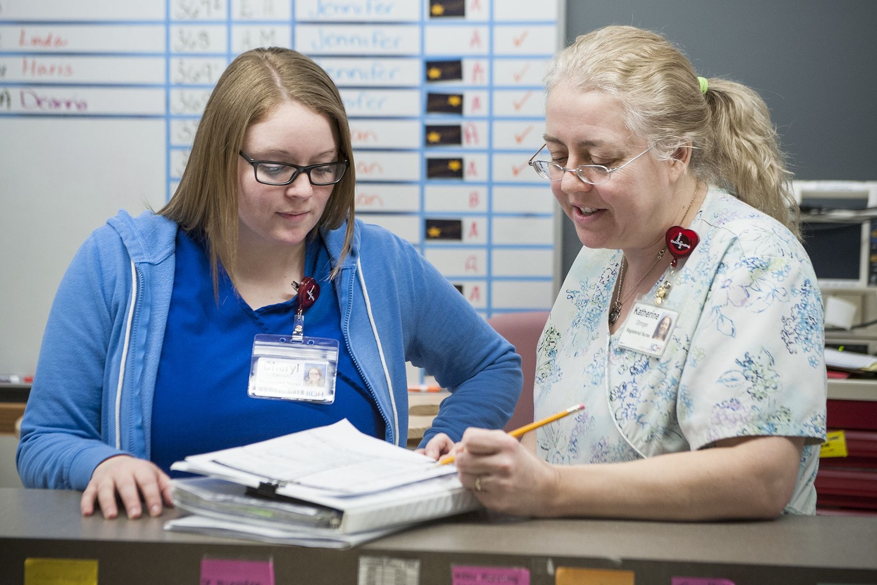 Cheryl Cannon, RN, and Katherine Stringer, Patient Care Navigator, wear the heart-shaped ID badge clips they received after completing the Communicate with HEART training program. 