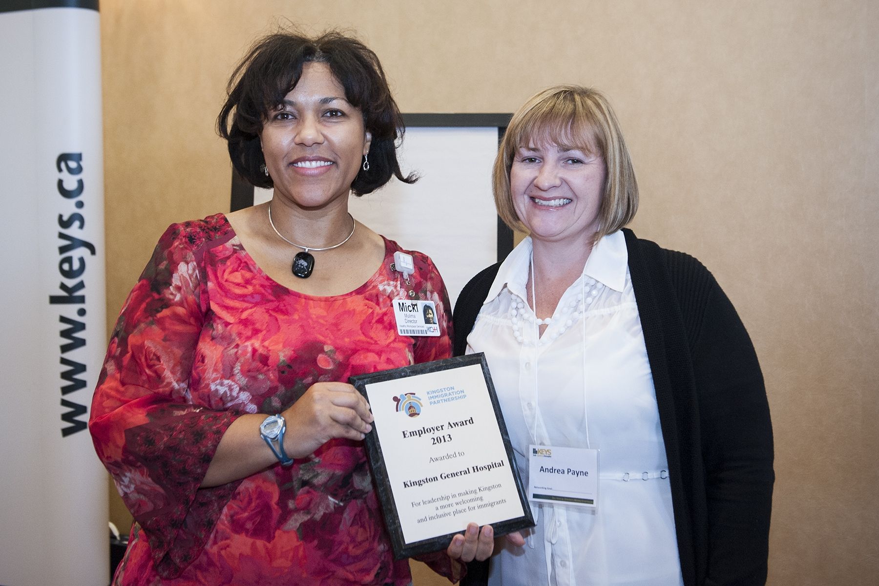 Micki Muima, Director of Healthy Workplace Services (left) accepts the Employer Award 2013 from Andrea Payne of the Kingston Immigration Partnership at the Residence Inn Mariott.