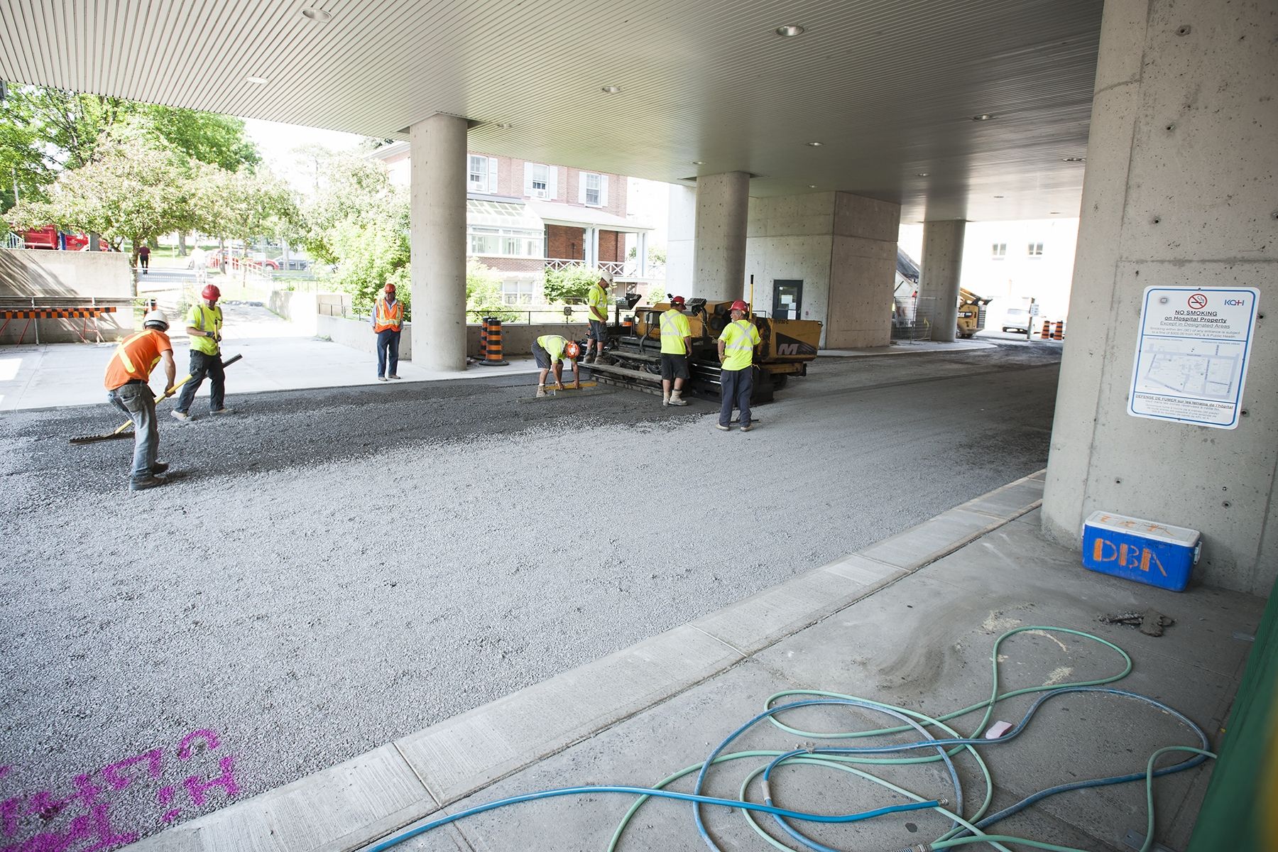 Construction crews prepare to lay asphalt under the front canopy.