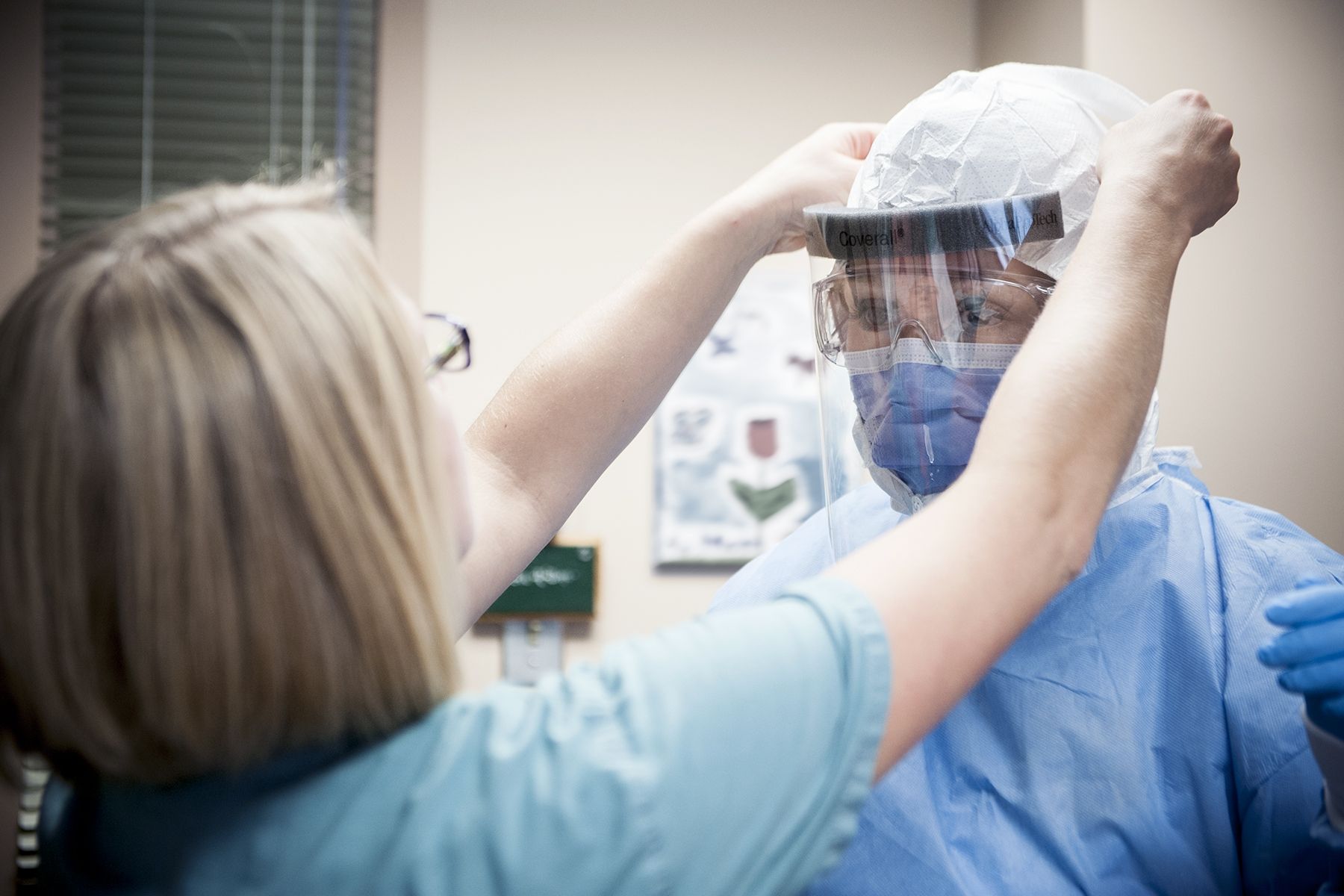 Staff at Kingston General Hospital work together in pairs and train on how to properly use enhanced personal protective equipment.