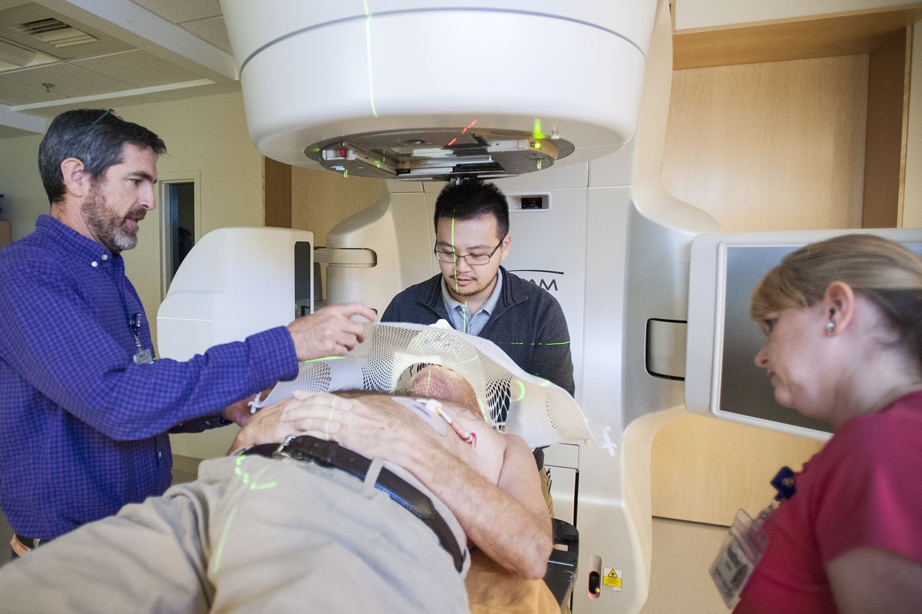 Members of the Radiation Therapy team make adjustments to the cancer centre’s new Linear Accelerator for patient Lance Sheppard