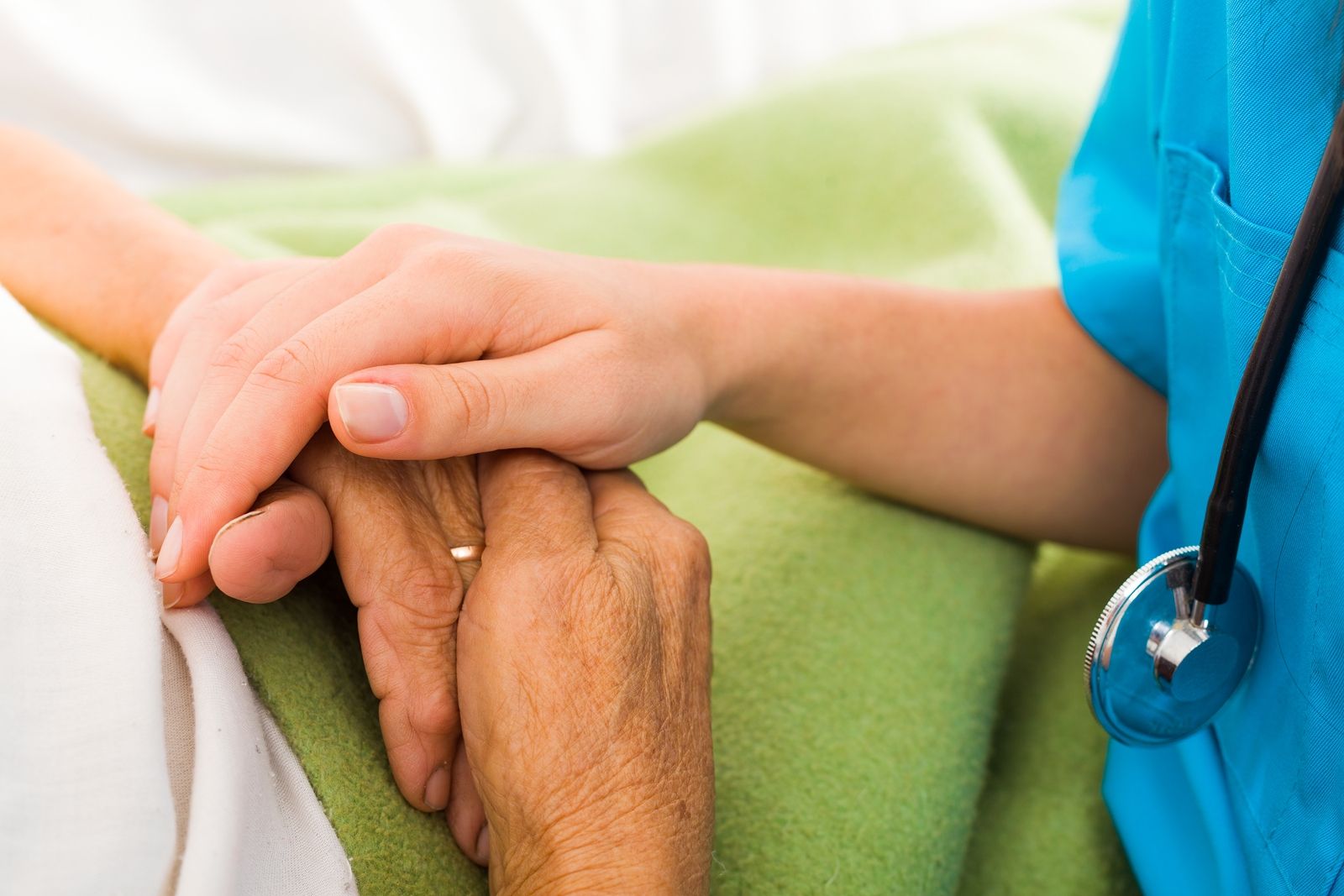 Nurse and elderly hands