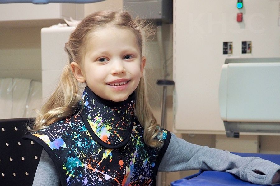 Ella models the new pediatric apron that was inspired by her experience in the Diagnostic Imaging department 